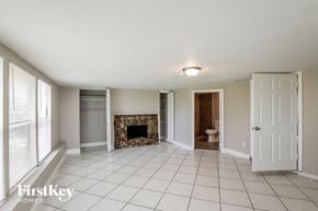 Fort Lauderdale house for rent - a living room with a tile floor and a fireplace