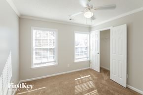 Woodstock house for rent - a bedroom with two windows and a ceiling fan