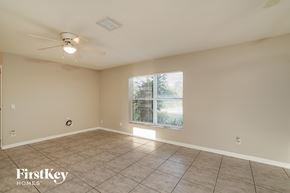 Lehigh Acres house for rent - the spacious living room has a ceiling fan and tile flooring