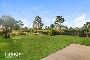 Lehigh Acres house for rent - a park with green grass and trees and a sidewalk