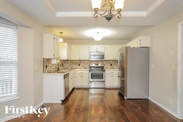 Kearney house for rent - A well-lit kitchen with a refrigerator, oven, and sink.