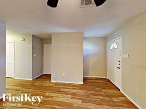 Grand Prairie house for rent - an empty living room with wood floors and a white door