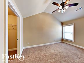 Loganville house for rent - the master bedroom has a ceiling fan and a closet