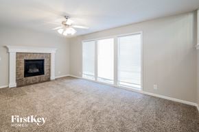 Belton house for rent - A spacious living room with a fireplace and carpeted floor.