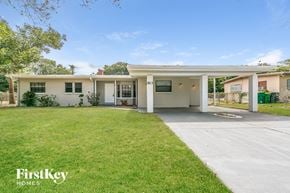 Cocoa house for rent - A house with a white exterior and a garage is for sale.