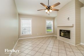Minneola house for rent - a living room with a fireplace and a ceiling fan