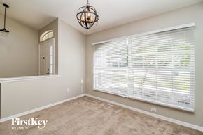Minneola house for rent - a bedroom with a large window and a carpeted floor