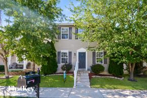 Lake Saint Louis house for rent - a white house with trees in front of it