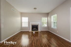 Lake Saint Louis house for rent - a living room with wood floors and a fireplace