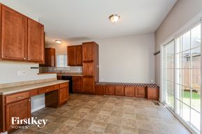 Lake Saint Louis house for rent - a kitchen with wooden cabinets and a large window
