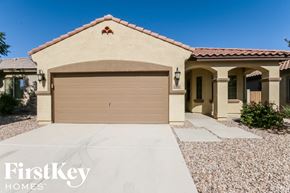 San Tan Valley house for rent - A house with a tan garage door and a brown roof.