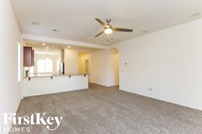 San Tan Valley house for rent - A spacious room with a ceiling fan and carpeted floor.