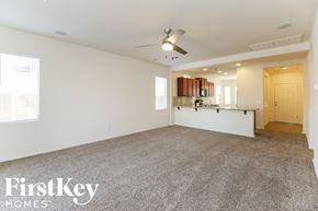San Tan Valley house for rent - A spacious room with a carpeted floor and a ceiling fan.