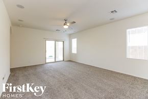 San Tan Valley house for rent - A spacious room with a carpeted floor and a ceiling fan.