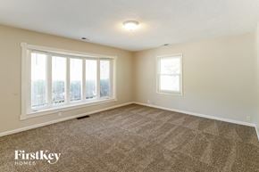 Olathe house for rent - an empty living room with a view of the city