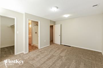 Olathe house for rent - a living room with carpet and a door to a bathroom