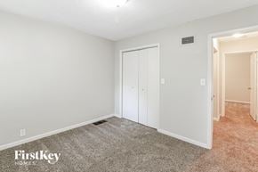 Olathe house for rent - a bedroom with white walls and carpet and a closet