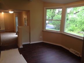 Matteson house for rent - a dining room with a large window and a wooden floor