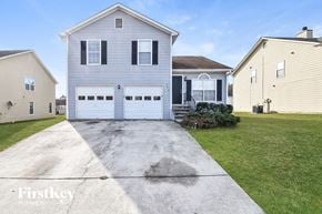 College Park house for rent - a white house with a driveway and a white garage door