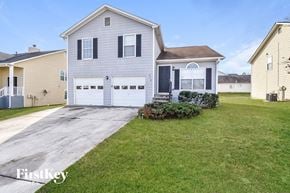College Park house for rent - a white house with a driveway and a lawn