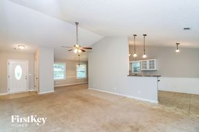 Woodstock house for rent - A spacious room with a ceiling fan and pendant lights.