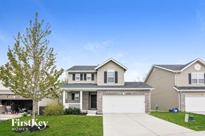 Wentzville house for rent - A house with a tree in front of it and the words "FirstKey Homes" on the bottom left.