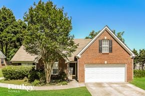 Lawrenceville house for rent - A brick house with a white garage door is for sale.