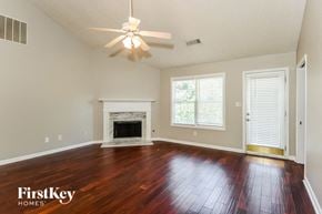 Lawrenceville house for rent - A spacious room with a fireplace and wood flooring.