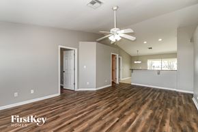 Cape Coral house for rent - the living room and dining room with wood flooring and a ceiling fan