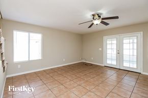 Chandler house for rent - A room with a ceiling fan and tile flooring.