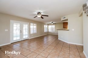 Chandler house for rent - A spacious room with a ceiling fan and tiled floor.