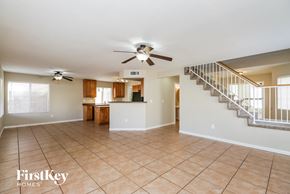 Chandler house for rent - A spacious living room with a staircase and a kitchen area.