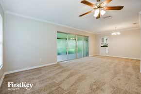 Winter Springs house for rent - A spacious room with a ceiling fan and a carpeted floor.