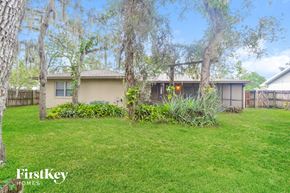 Winter Springs house for rent - A well-maintained lawn with a house and trees in the background.