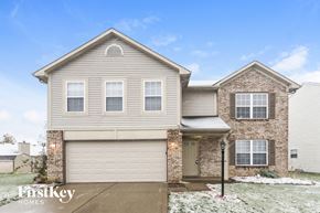 Indianapolis house for rent - A house with a garage and a brick chimney is for sale.