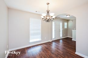 Mcdonough house for rent - a living room with a hard wood floor and a chandelier