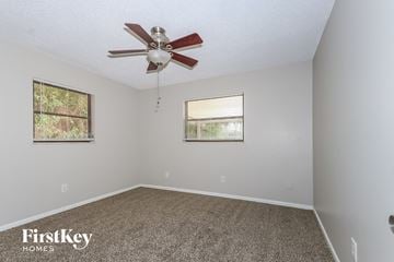 Port St. Lucie house for rent - the living room has a ceiling fan and carpet