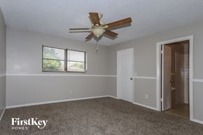 Port St. Lucie house for rent - a bedroom with a ceiling fan and a door to a closet