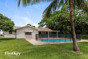 Port St. Lucie house for rent - a house with a swimming pool and a fence