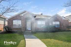 Rockwall house for rent - a brick house with a sidewalk in front of it