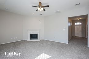 Rockwall house for rent - the living room with fireplace and ceiling fan