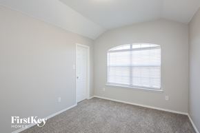 Rockwall house for rent - a bedroom with white walls and a window and a door