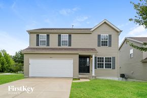 O'fallon house for rent - a tan house with a white garage door