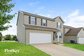 O'fallon house for rent - a tan house with a white garage door