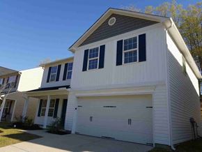 Fuquay Varina house for rent - A two-story house with a white garage door.