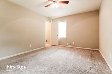 Forest Park house for rent - the spacious living room with carpet and ceiling fan