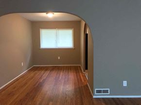 Florissant house for rent - an empty living room with wood floors and a window