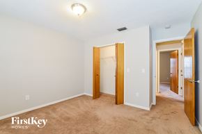 Deltona house for rent - a bedroom with a carpeted floor and a door to a closet