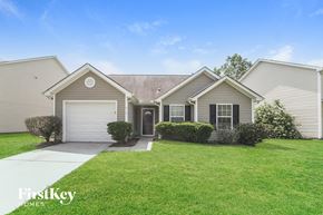 Charlotte house for rent - a home with a lawn and a sidewalk in front of it