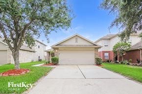 Channelview house for rent - a white house with a driveway and a tree